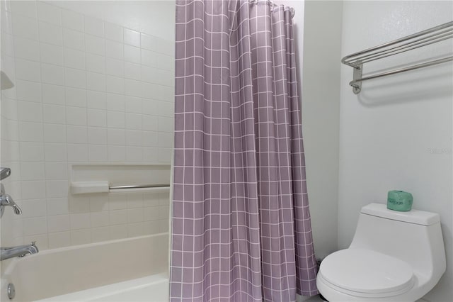 bathroom featuring shower / bath combination with curtain and toilet