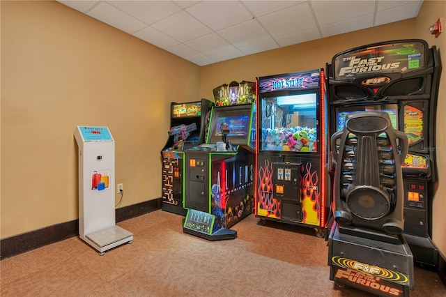 playroom featuring a drop ceiling and dark colored carpet