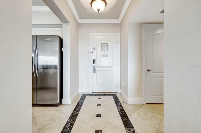 foyer with crown molding and baseboards