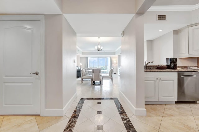 hallway with recessed lighting, baseboards, an inviting chandelier, visible vents, and crown molding