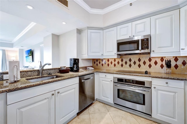 kitchen with sink, white cabinets, stone counters, stainless steel appliances, and crown molding