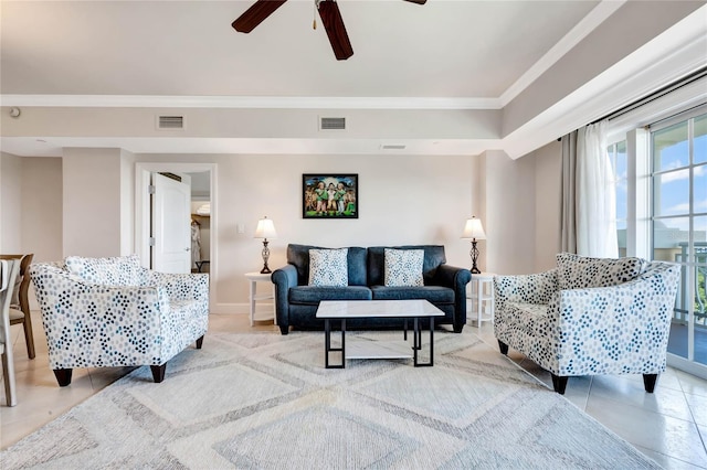 living room with crown molding, light tile patterned flooring, and ceiling fan