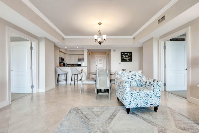 sitting room with an inviting chandelier, a tray ceiling, crown molding, and light tile patterned floors