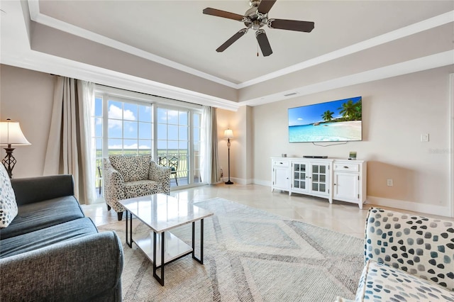 tiled living room with ornamental molding and ceiling fan