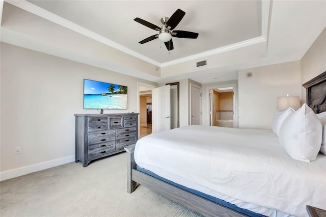 bedroom with a raised ceiling, light carpet, and ceiling fan