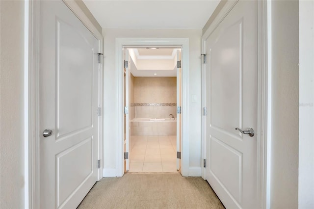 corridor with light colored carpet and baseboards