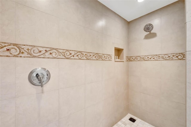 bathroom with tile walls and tiled shower