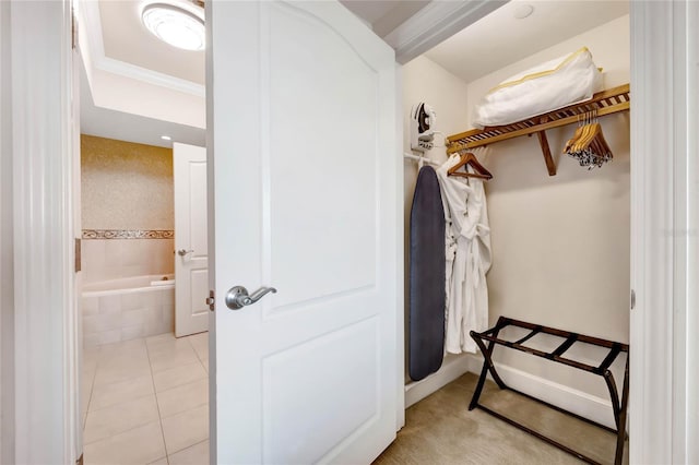 walk in closet with light tile patterned floors