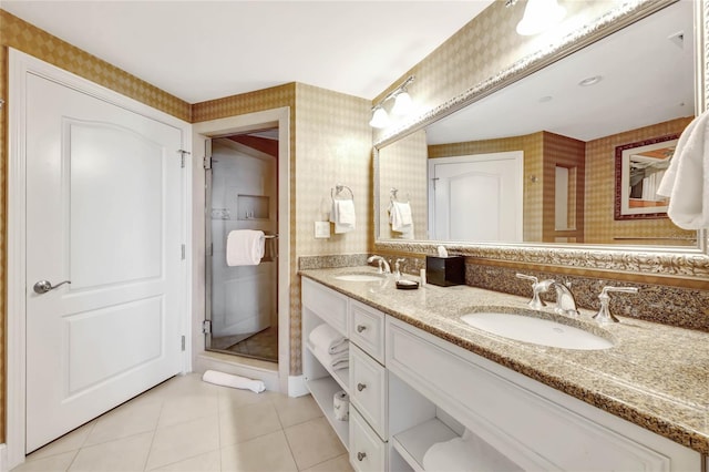 bathroom featuring a sink, double vanity, wallpapered walls, and tile patterned flooring