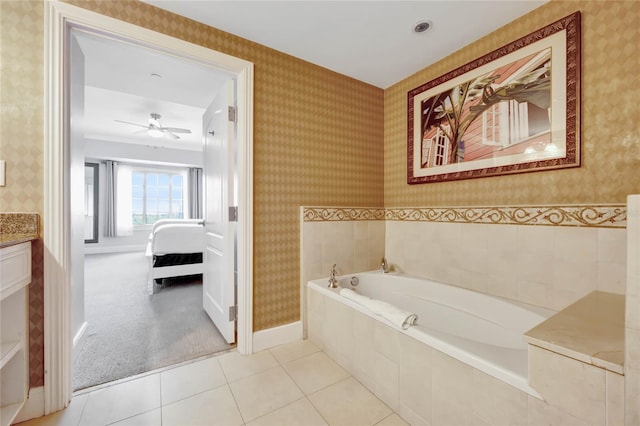 bathroom with ceiling fan, tiled bath, vanity, and tile patterned floors