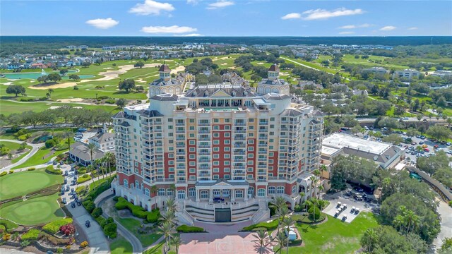 drone / aerial view featuring view of golf course and a water view