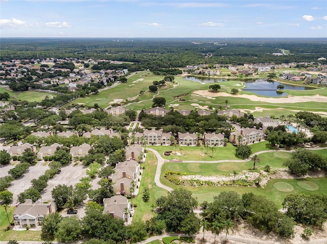 birds eye view of property featuring view of golf course, a water view, and a residential view