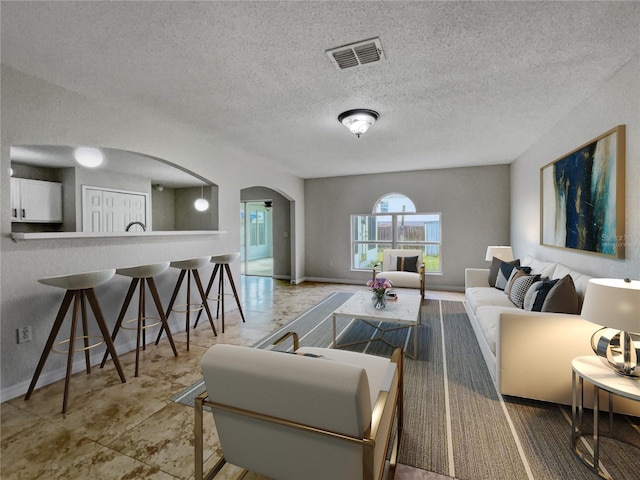 living room featuring a textured ceiling