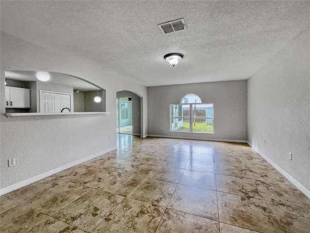 unfurnished living room with a textured ceiling