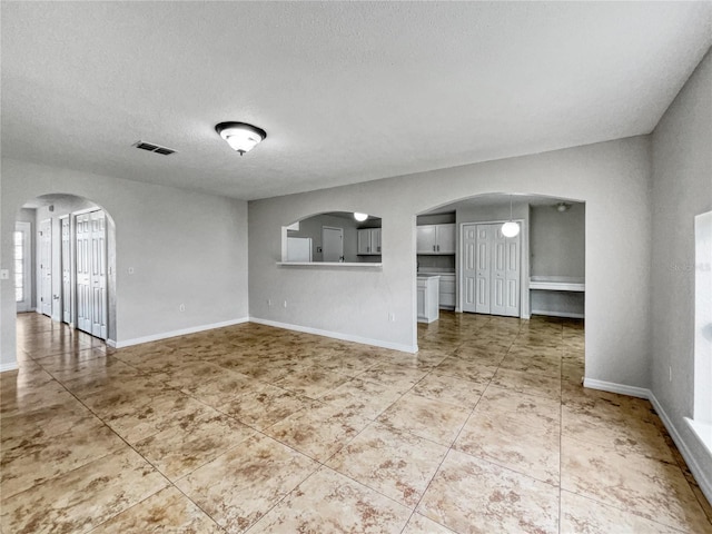 unfurnished living room with a textured ceiling