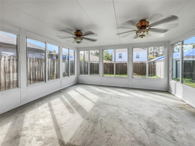 unfurnished sunroom with ceiling fan