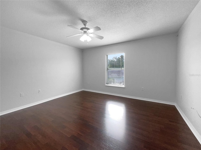 spare room with ceiling fan, dark hardwood / wood-style flooring, and a textured ceiling