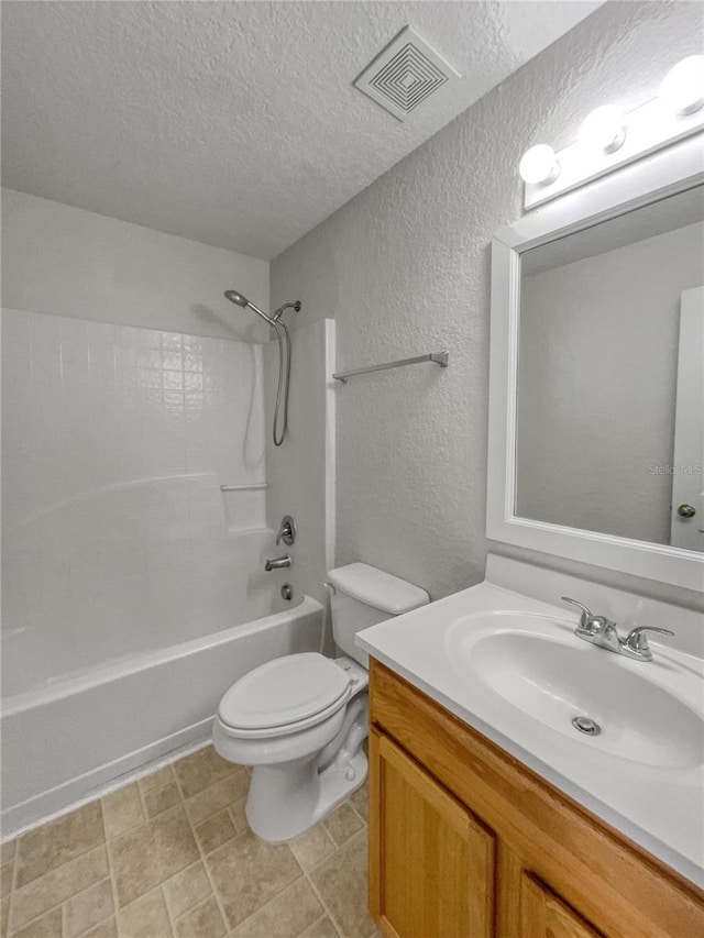 full bathroom with shower / bathing tub combination, vanity, toilet, and a textured ceiling