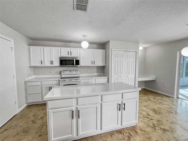 kitchen with light tile patterned floors, a kitchen island, a textured ceiling, white cabinetry, and white electric stove