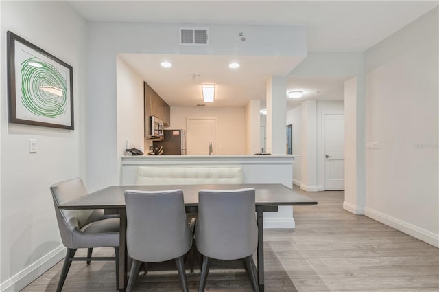 dining area with light wood-type flooring