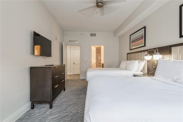 bedroom featuring connected bathroom, ceiling fan, and dark carpet