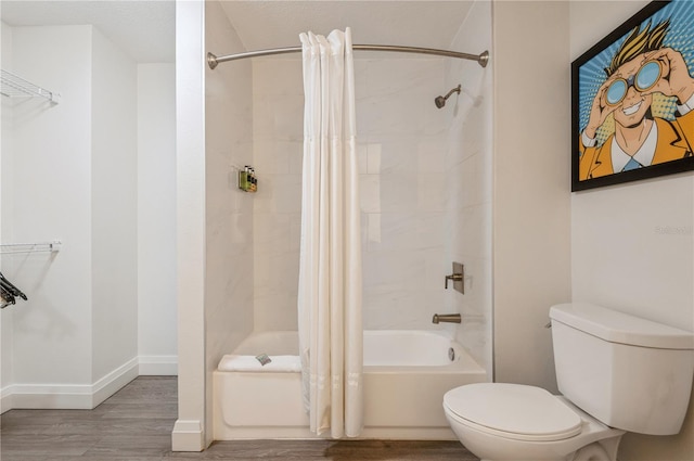 bathroom with a textured ceiling, toilet, shower / tub combo, and wood-type flooring