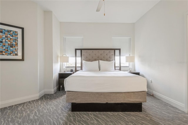 bedroom with multiple windows, ceiling fan, and dark colored carpet