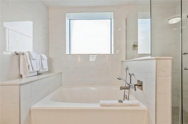 bathroom with tile walls and a washtub