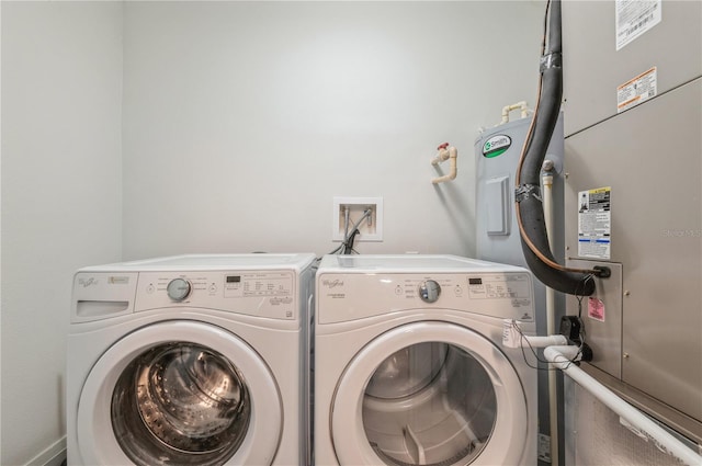 washroom with washer and dryer, washer hookup, and heating utilities