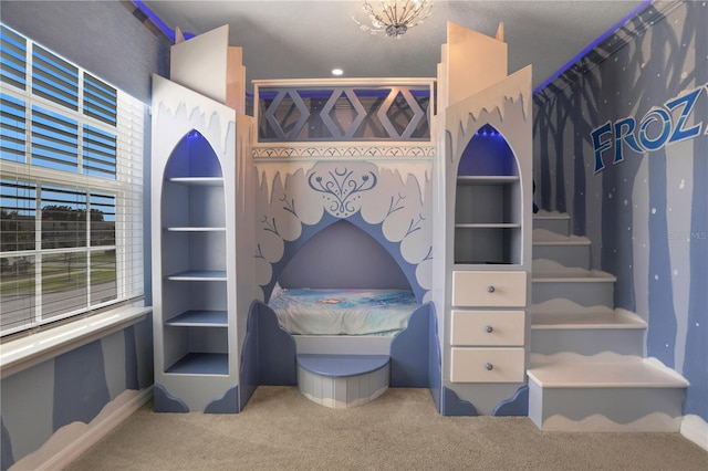 walk in closet with a chandelier and carpet