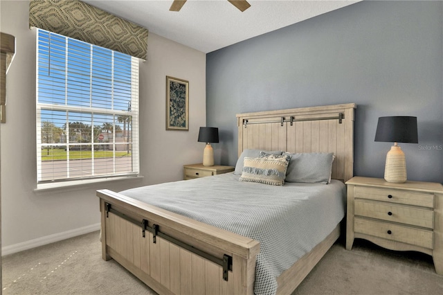 bedroom featuring light carpet and ceiling fan