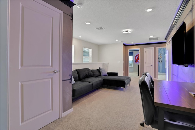 carpeted home office featuring a textured ceiling and crown molding