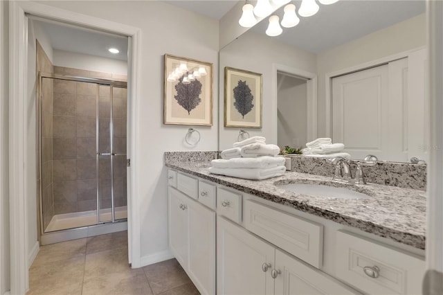 bathroom with walk in shower, tile floors, and vanity