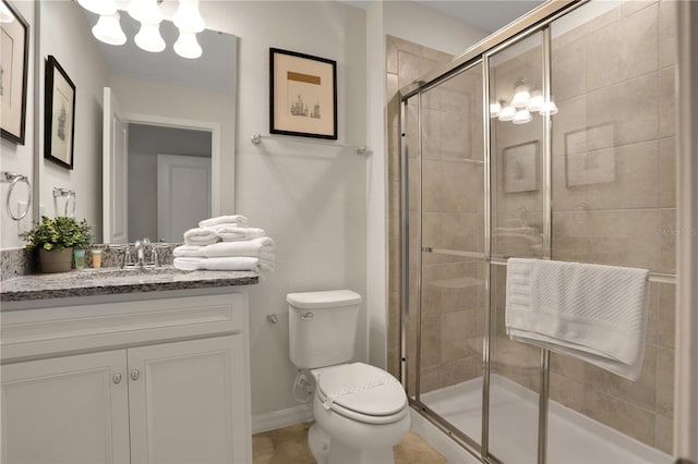 bathroom with toilet, a shower with door, tile flooring, an inviting chandelier, and vanity