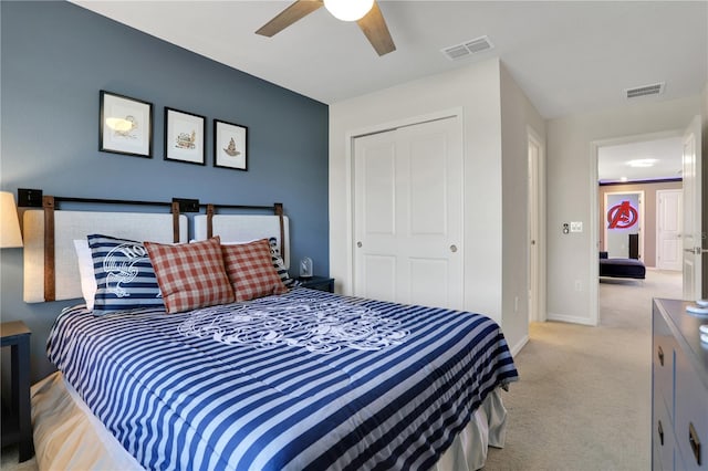 bedroom featuring a closet, light colored carpet, and ceiling fan