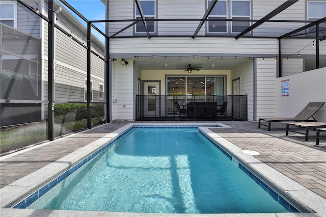 view of pool featuring ceiling fan, a patio, and a lanai