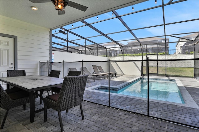 view of pool featuring a patio, ceiling fan, and a lanai