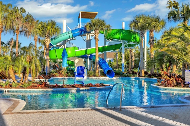 view of swimming pool with a water slide