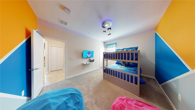 bedroom with a textured ceiling and carpet floors