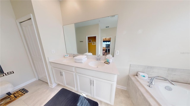 bathroom with a relaxing tiled bath, double vanity, and tile flooring