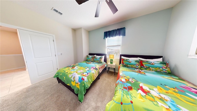 tiled bedroom featuring ceiling fan