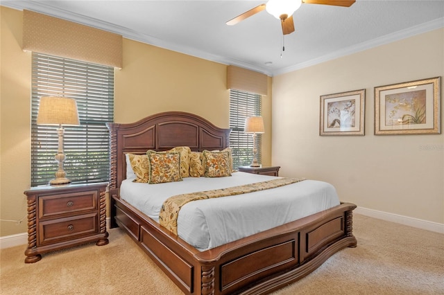 carpeted bedroom featuring crown molding and ceiling fan