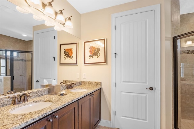 bathroom featuring oversized vanity, dual sinks, and walk in shower