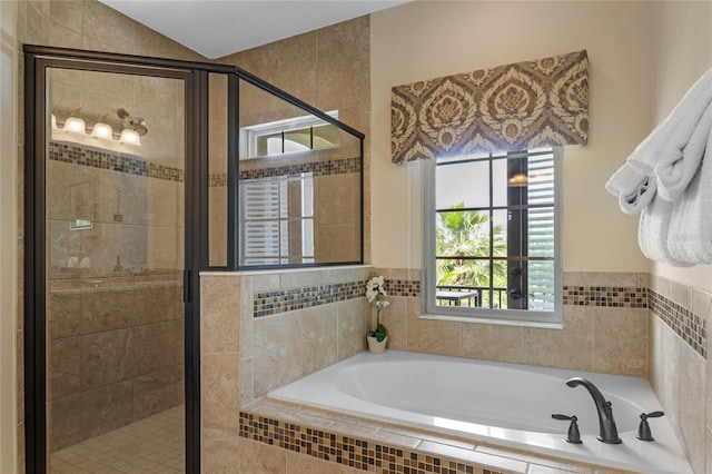 bathroom featuring separate shower and tub