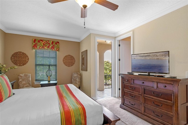 bedroom featuring light carpet, ceiling fan, a textured ceiling, ornamental molding, and access to outside