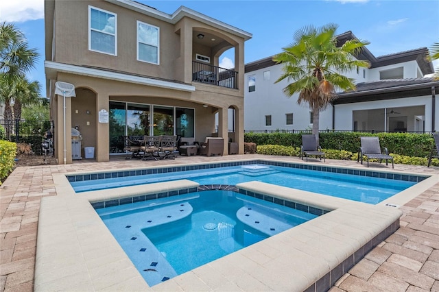 view of swimming pool with a grill, an in ground hot tub, and a patio area