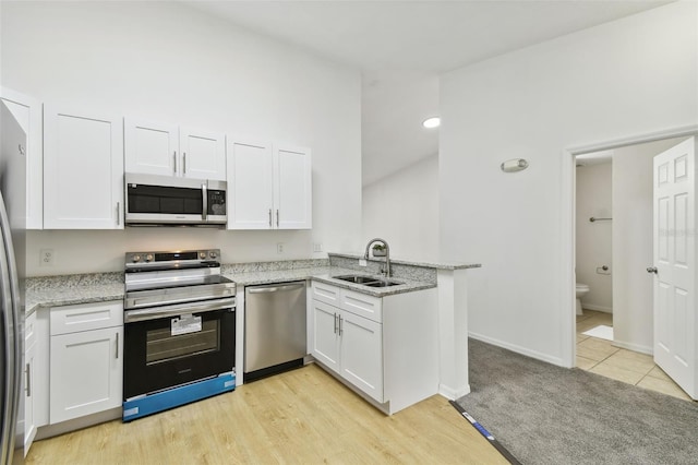 kitchen with white cabinetry, sink, and appliances with stainless steel finishes