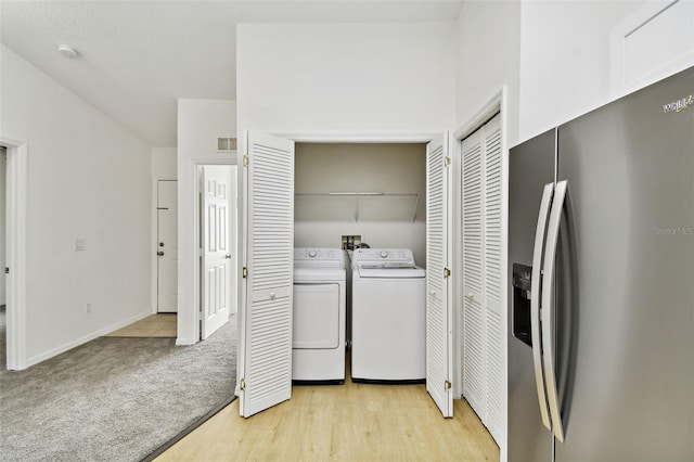 laundry room featuring independent washer and dryer and light wood-type flooring