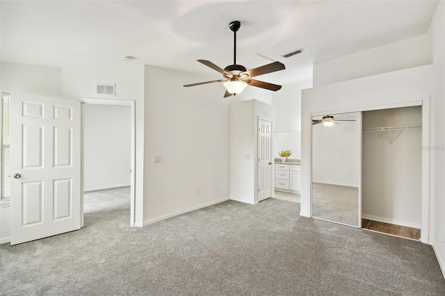 unfurnished bedroom featuring ceiling fan, a closet, and light carpet