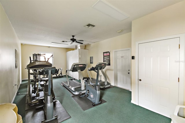 exercise room with dark colored carpet and ceiling fan